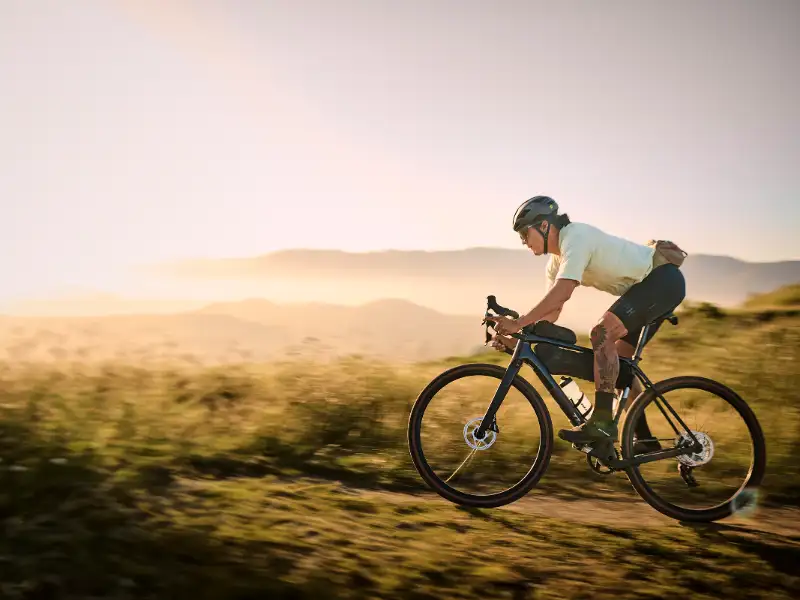 Ein JobRadler fährt an der Küste ein Trek Gravelbike im Sonnenuntergang